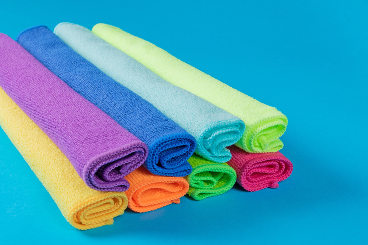 Rolled Microfiber Towels On Blue Background 1200X800